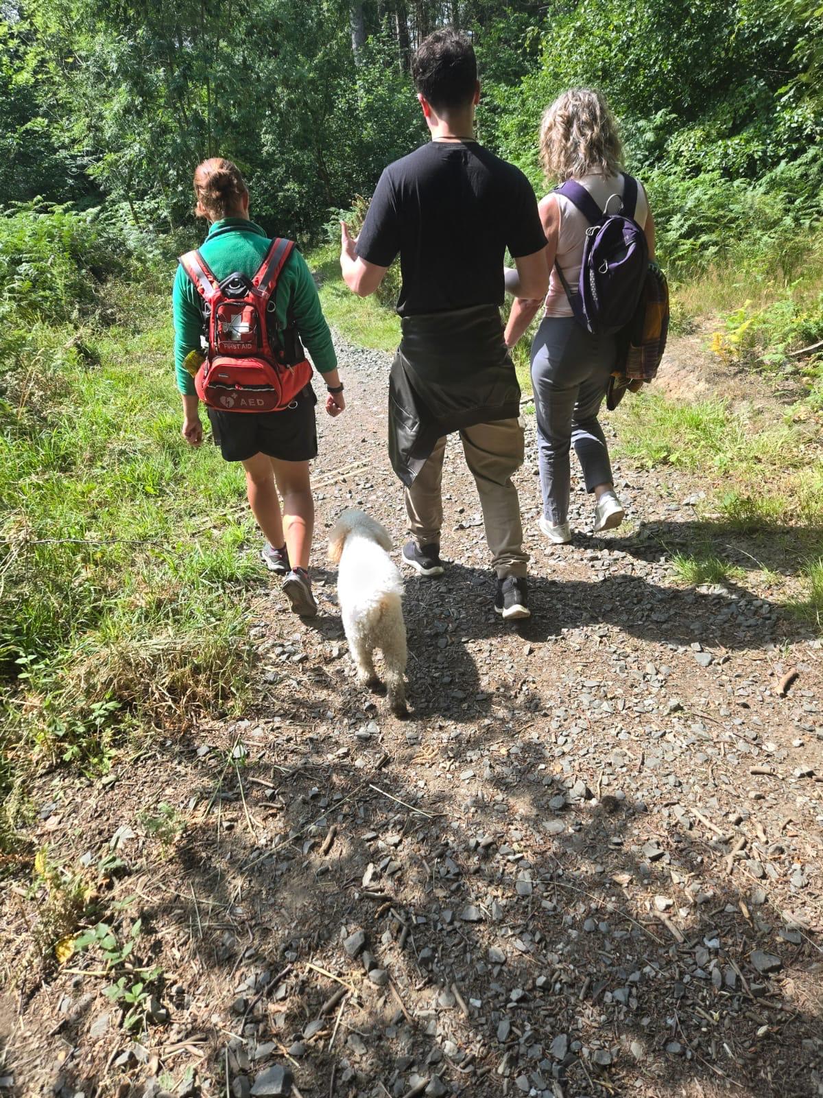 Participants in a guided grief walk sharing quiet reflection outdoors during nature based healing session